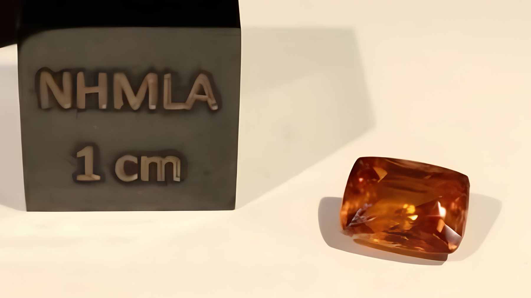 The rarest mineral recognized by science weighs about 0.011 ounces, exists as a single known natural specimen, and its discovery exposes how fragile Earth’s catalog still is 1 A close-up view of a tiny, reddish-orange kyawthuite crystal, the only confirmed natural specimen of this mineral species in existence.