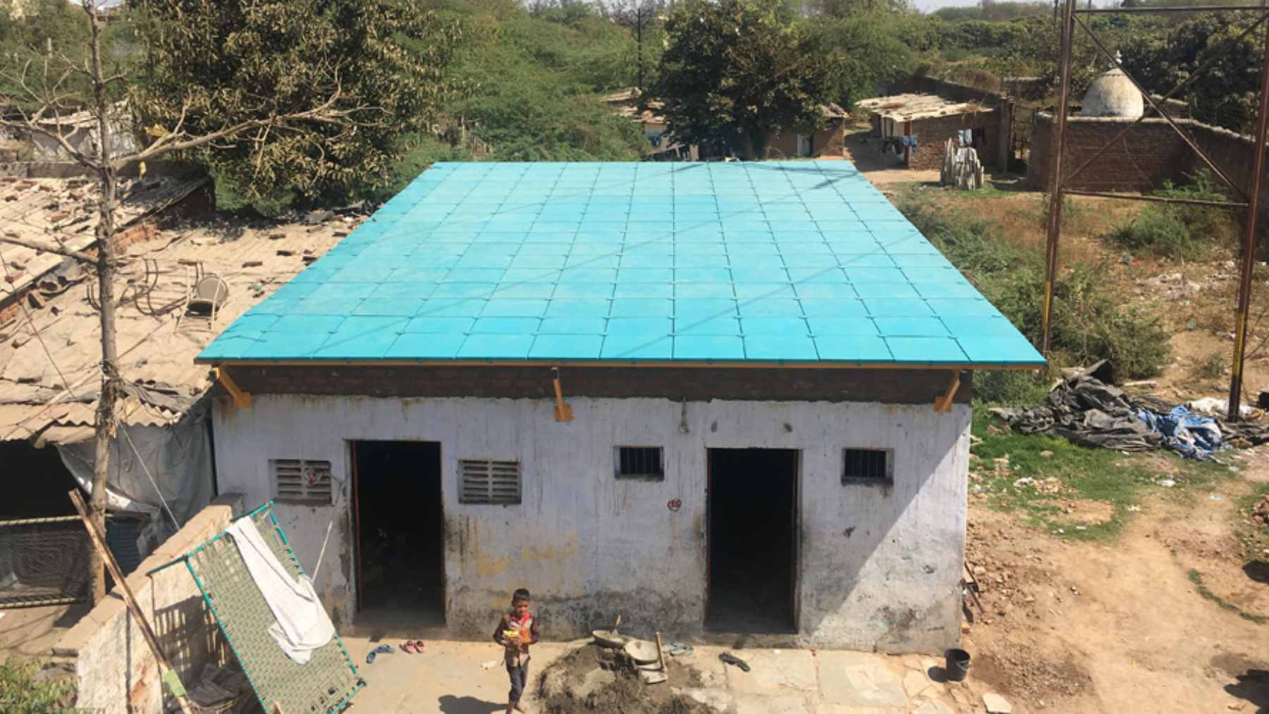 A man builds roofs from cardboard and farm waste for precarious homes, and after installing hundreds he proves impact can be humble, cheap, and scalable 1 ModRoof modular panels made from recycled cardboard and coconut husk fiber being installed on a low-income home.