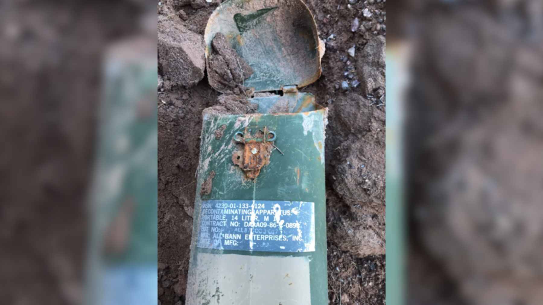 Weathered decontamination canisters found abandoned in a remote, rocky ravine near Dixon, New Mexico.