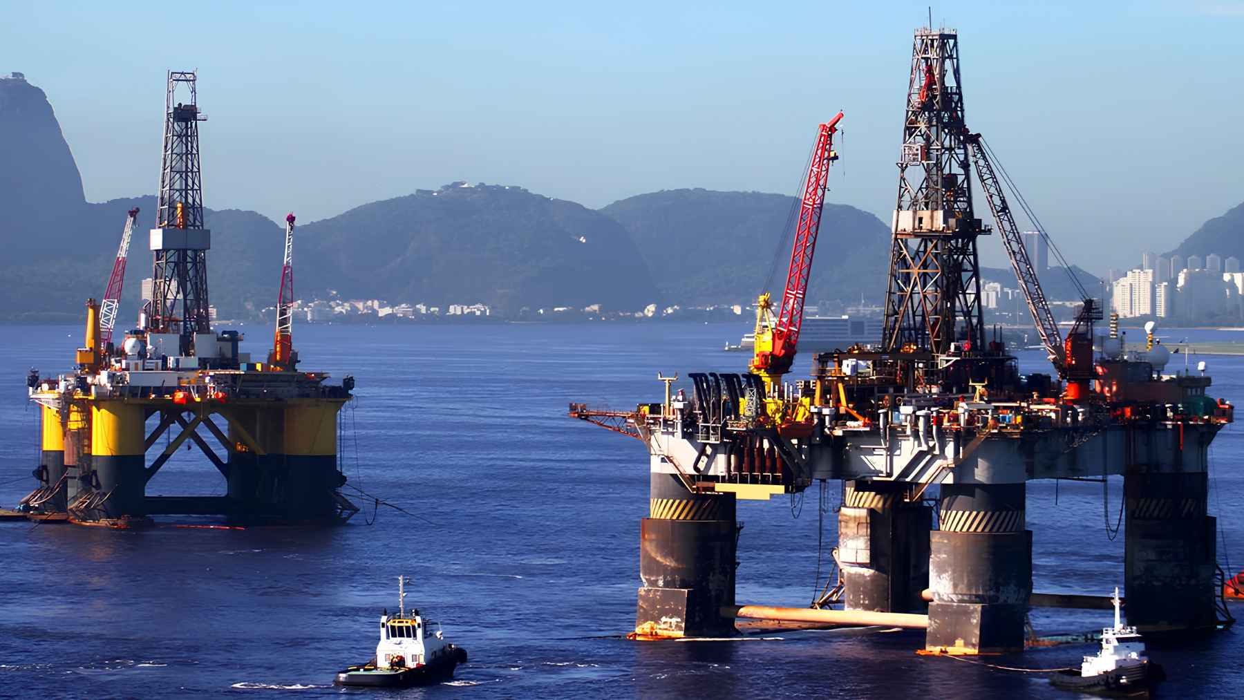 While Brazil debated the energy transition, Petrobras greenlit 11 new pre-salt platforms through 2027, and Búzios alone will get 6 FPSOs as it targets 1 million barrels a day 1 Offshore oil platforms operating near the Brazilian coast, showing deepwater drilling activity and support vessels.