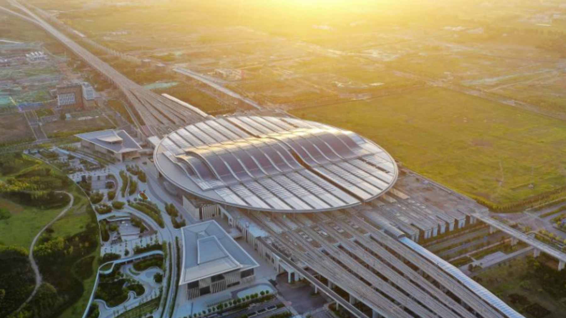 China built Asia’s largest rail station in just two years, with about 5.1 million square feet, solar power, and welding robots, and the scale shows who’s setting the infrastructure pace 1 The expansive oval-shaped roof and architectural interior of the massive Xiong’an Railway Station in China.