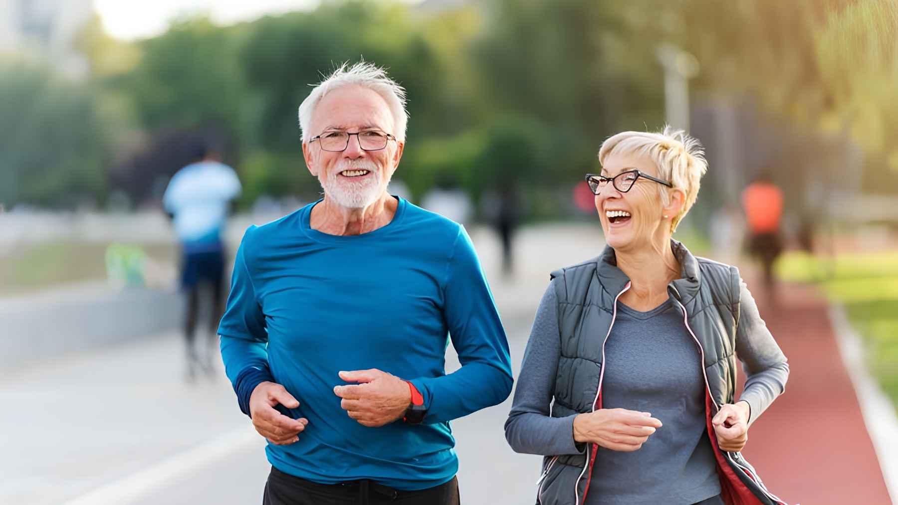 Older couple jogging together outdoors, showing active aging and long-term fitness through daily movement.