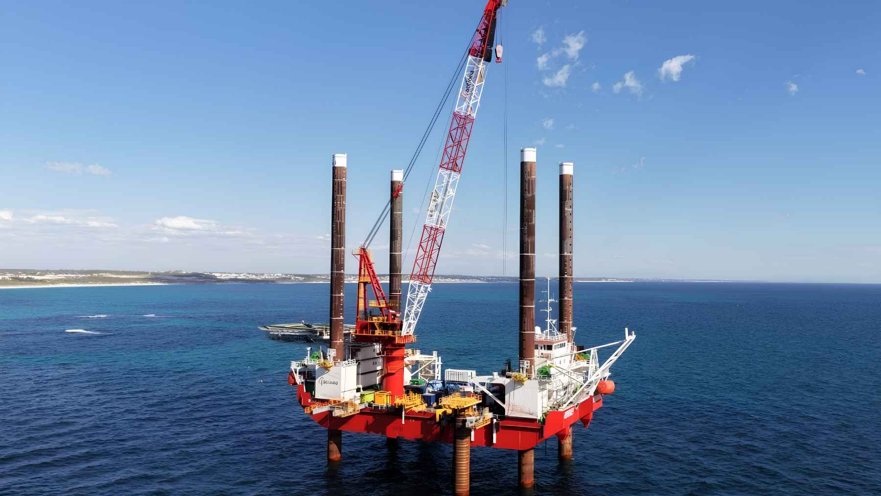 Jack-up barge with tall legs installing offshore desalination structures near Alkimos, Western Australia.