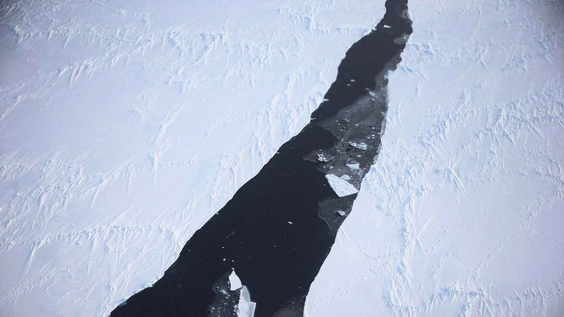 ECOnews 1 Aerial view of a large crack in Antarctic sea ice exposing dark ocean water between ice sheets.
