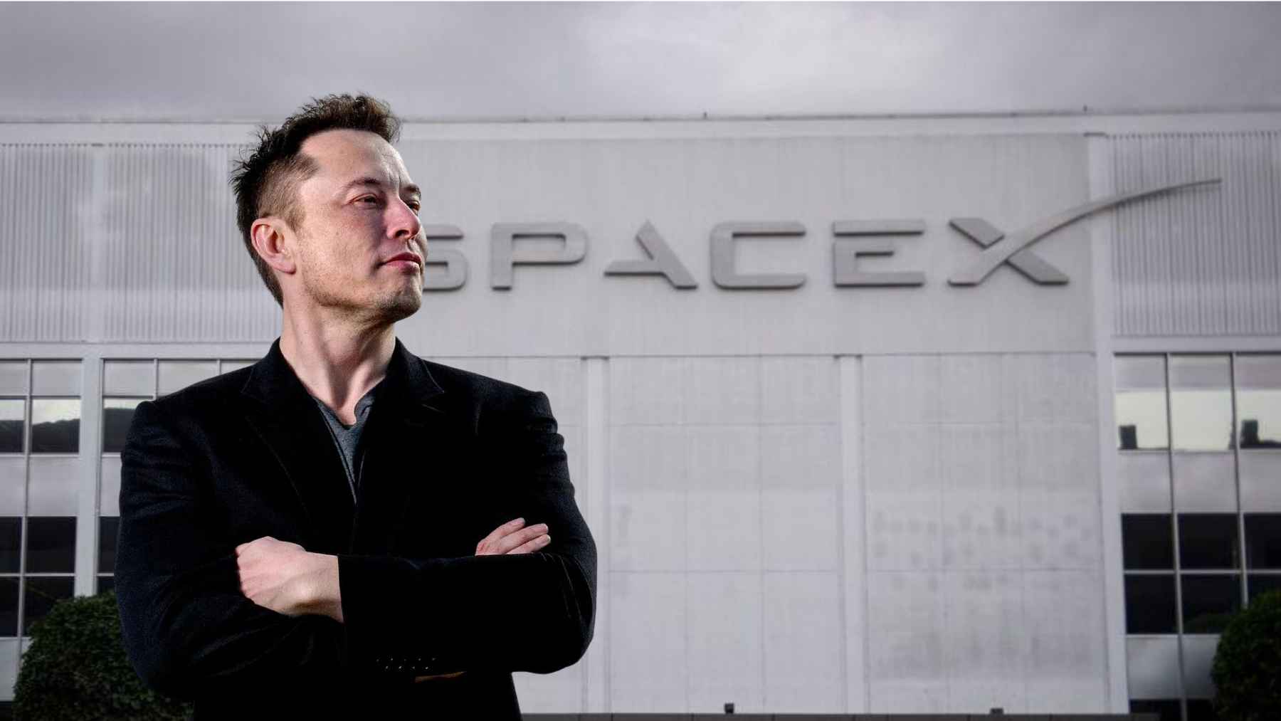 Elon Musk stands in front of SpaceX headquarters in Hawthorne, California, as the company pushes deeper into AI and market expansion.