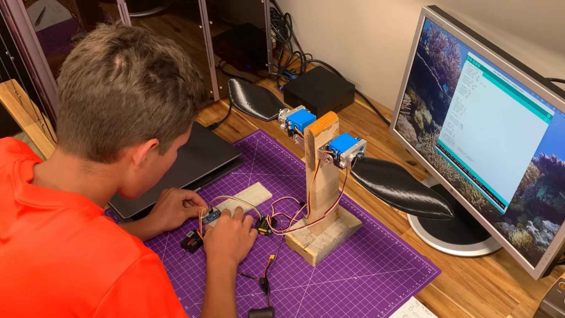 A 15-year-old in Ontario built a bionic underwater “robot turtle” that swims like a snapping turtle instead of using loud propellers, and its onboard AI can flag coral bleaching, invasive species, and plastic waste with 96% detection accuracy 1 Ontario student Evan Budz works on the electronics and biomimetic flipper system used in the BURT robotic turtle project.