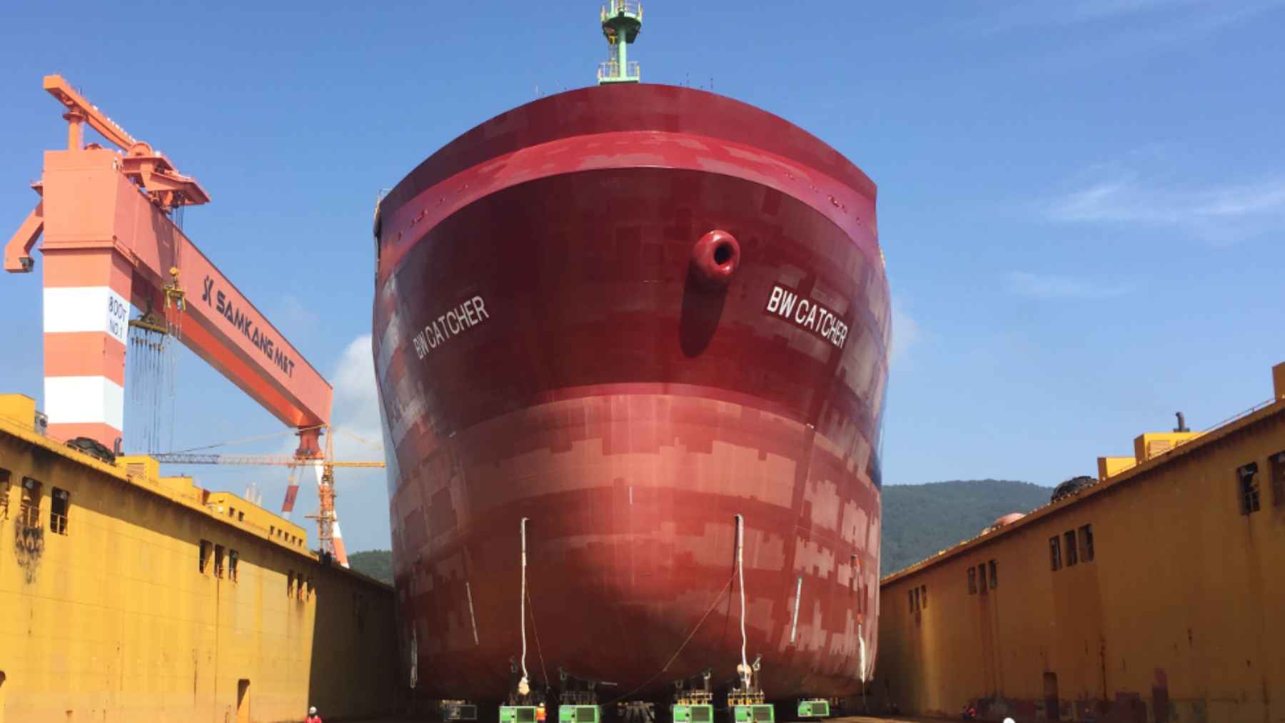 Massive ship block positioned on modular transporters inside a Korean shipyard before heavy transport.