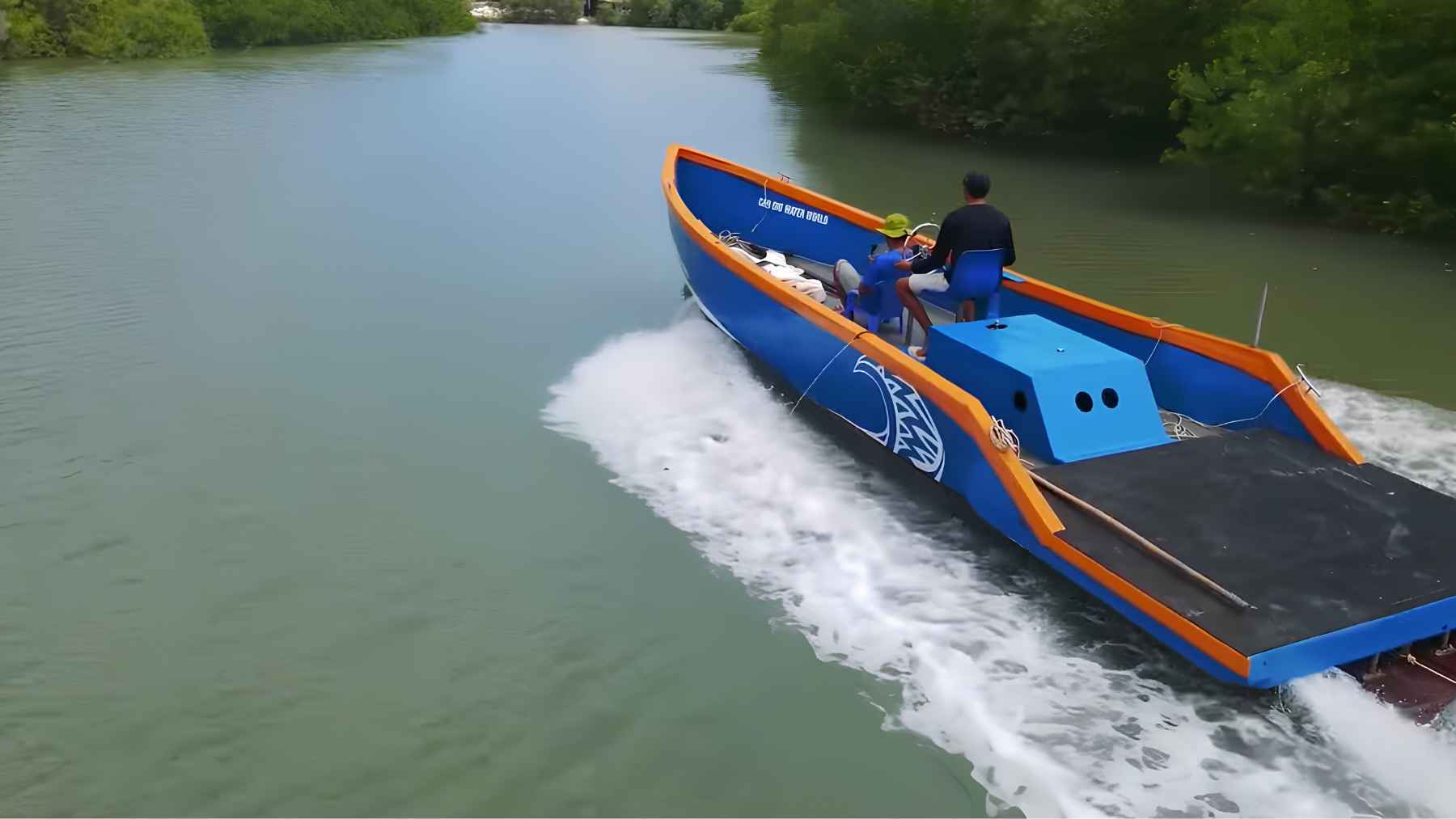 Homemade boat powered by a converted car engine moving across a river.