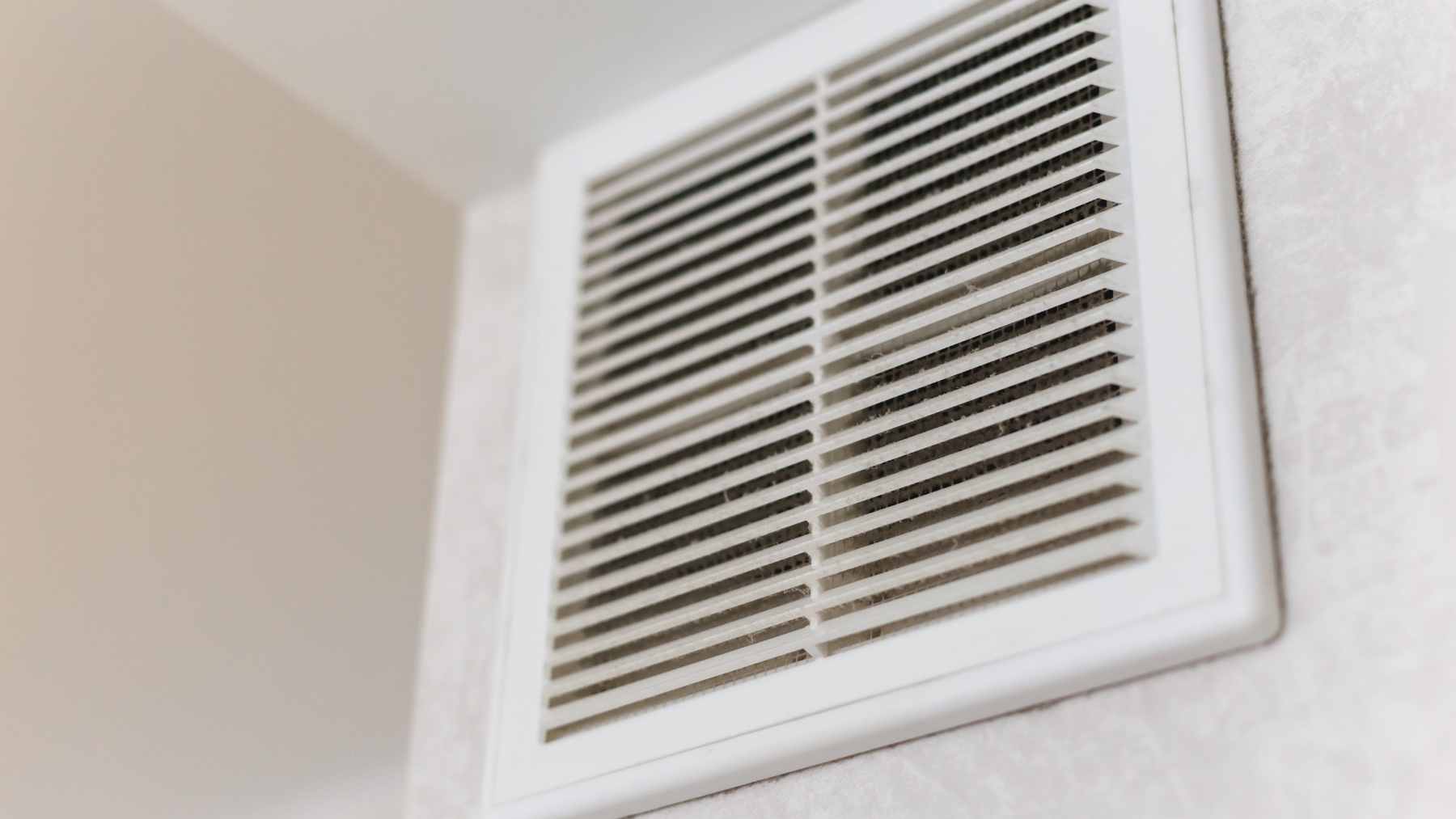 A close-up of a residential wall-mounted HVAC air vent, demonstrating the airflow that is restricted when these registers are closed.