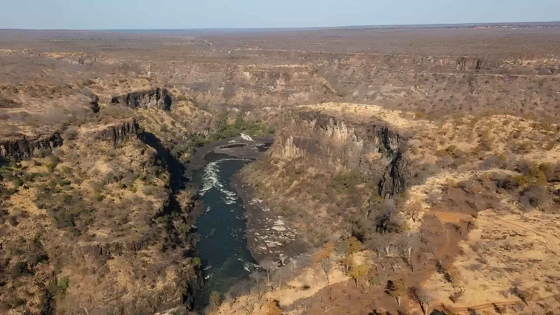 Helium bubbling out of hot springs along Zambia’s Kafue Rift is carrying a deep-mantle signature, and researchers say it could be the first hard evidence that a 1,550-mile Southwest African Rift is waking up into a new plate boundary that could eventually split the continent 1 Aerial view of a rift valley in Zambia where scientists detected signs of deep Earth activity.