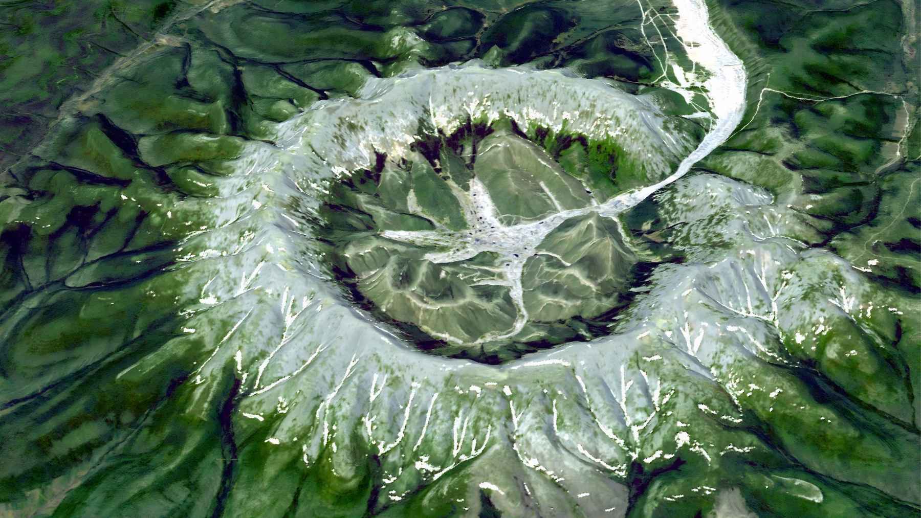 Satellite view of the Kondyor Massif circular ring structure in eastern Russia, showing its raised ridge and central basin.