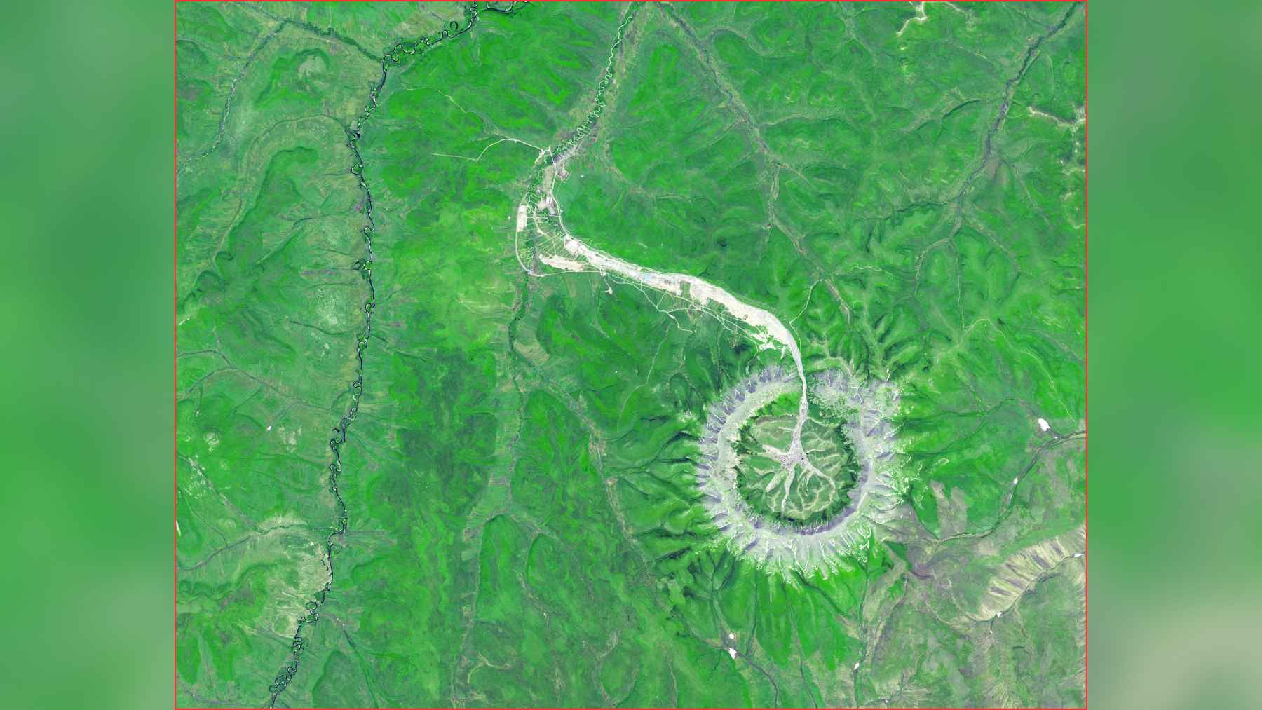 A perfect 3.7-mile ring in far eastern Russia puzzles NASA satellites, it looks like a crater or volcano, but the agency says it is neither, and that is the mystery 1 Wide satellite image of the Kondyor Massif in Russia, a near-perfect circular formation surrounded by green terrain.