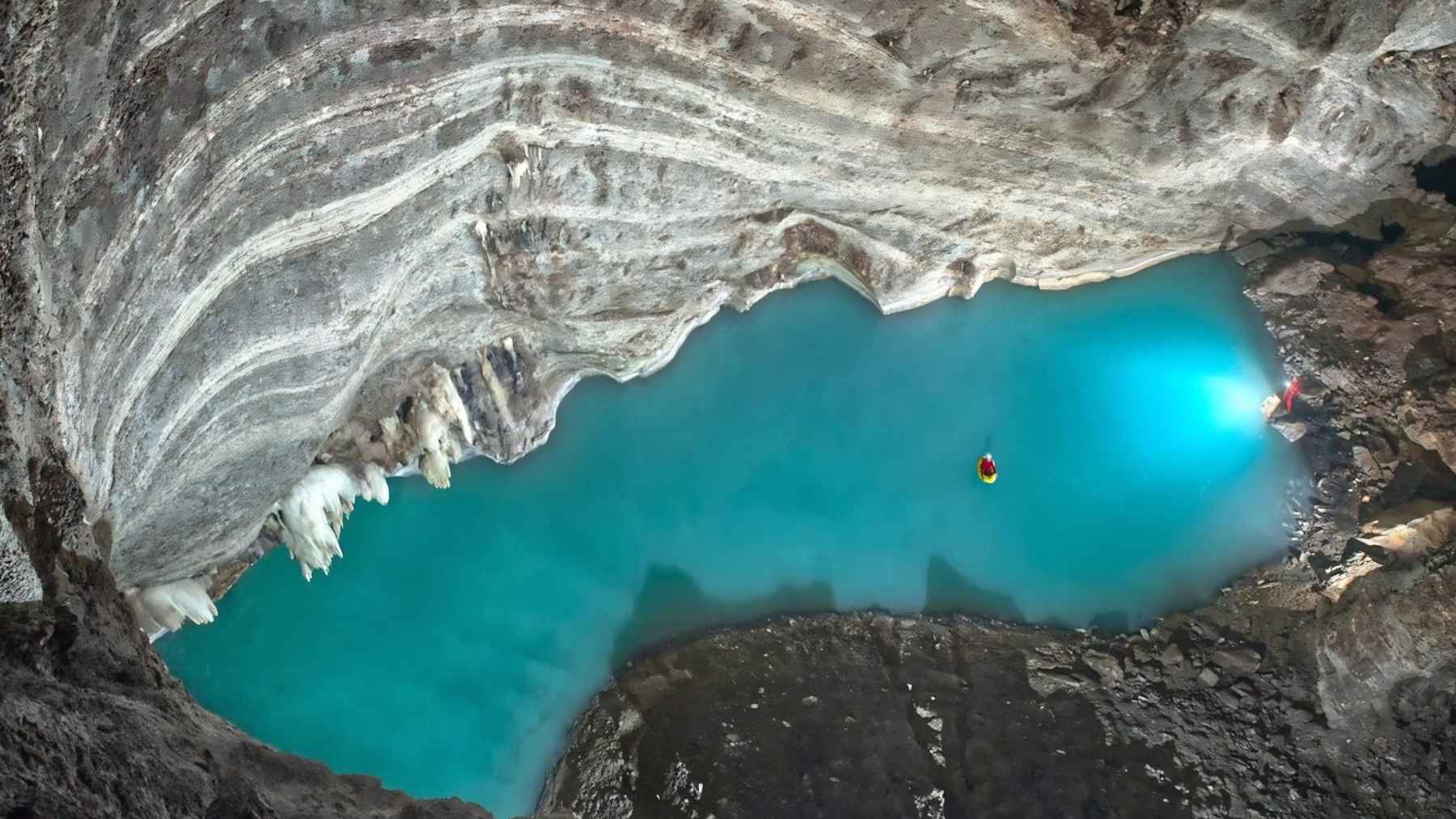 Turquoise waters of Lake Neuron inside a cave system in southern Albania, the largest known underground thermal lake.