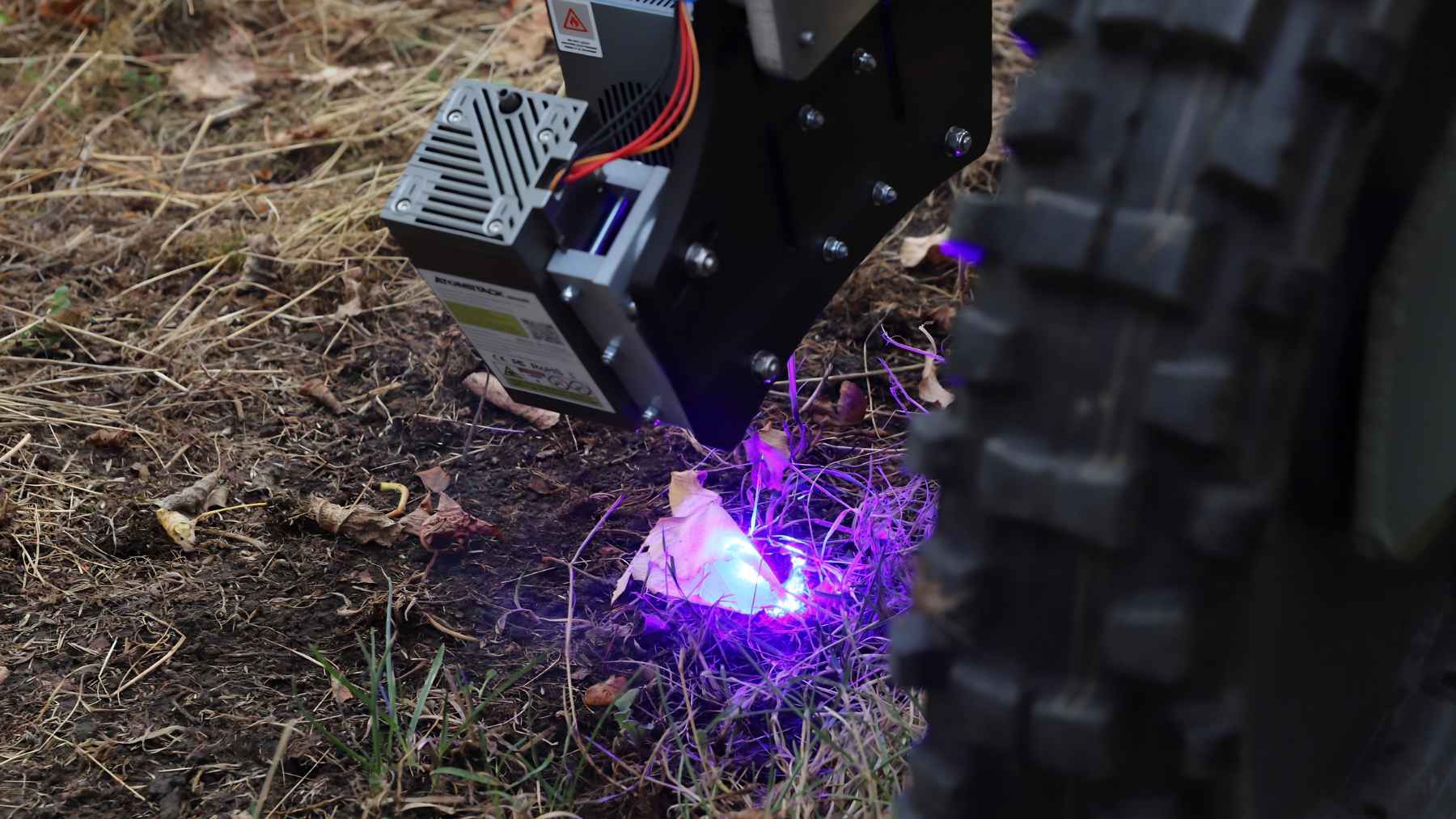 Germany is literally zapping crops with lasers to ditch pesticides, and early tests say the crazy plan just might pay off 1 Close-up of a laser weeding robot targeting a weed on the ground using precision energy.