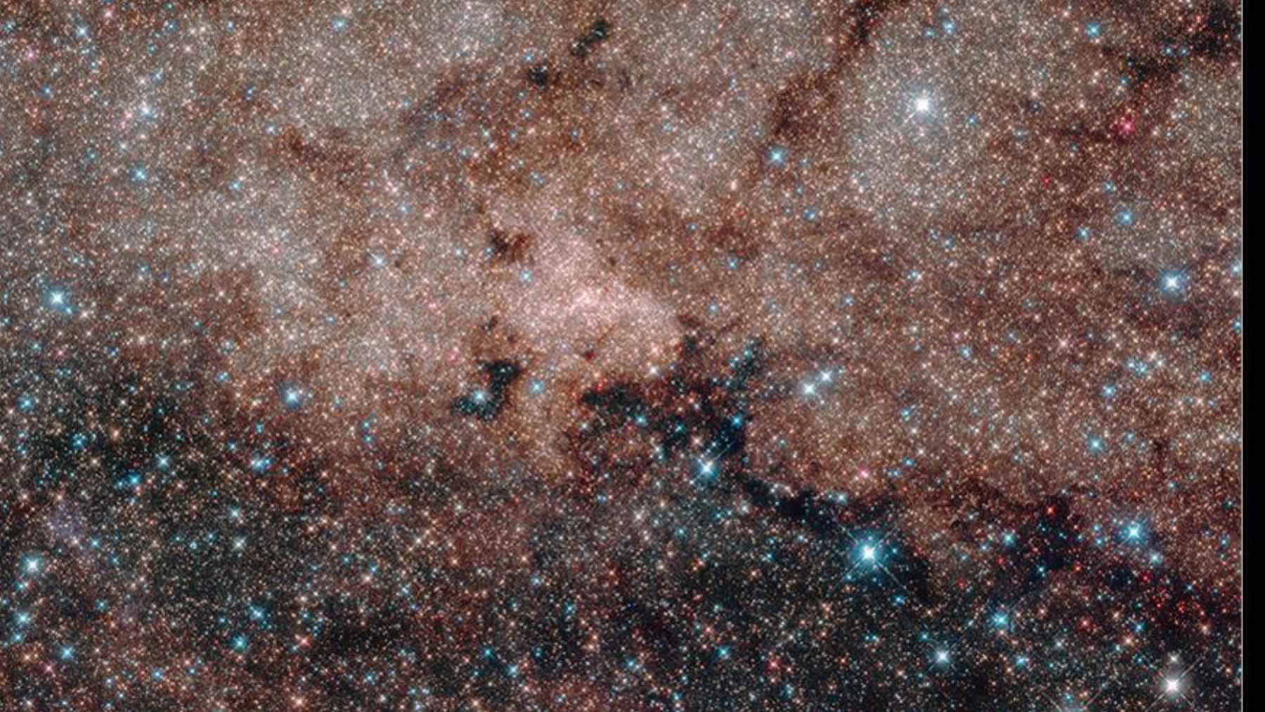 Hubble image of the Milky Way’s Galactic Center showing the dense star field around Sagittarius A*, where astronomers identified a mysterious mini-cavity.