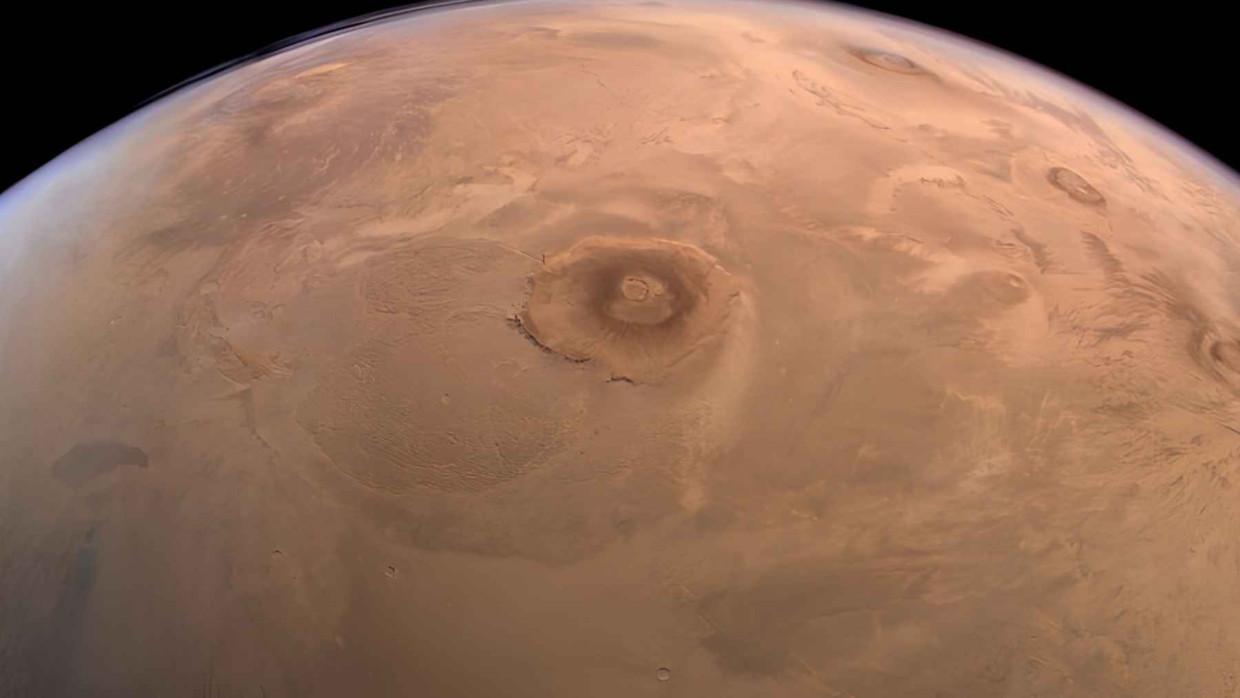 Olympus Mons on Mars, the largest volcano in the solar system, where researchers detected seasonal water frost near the summit caldera.