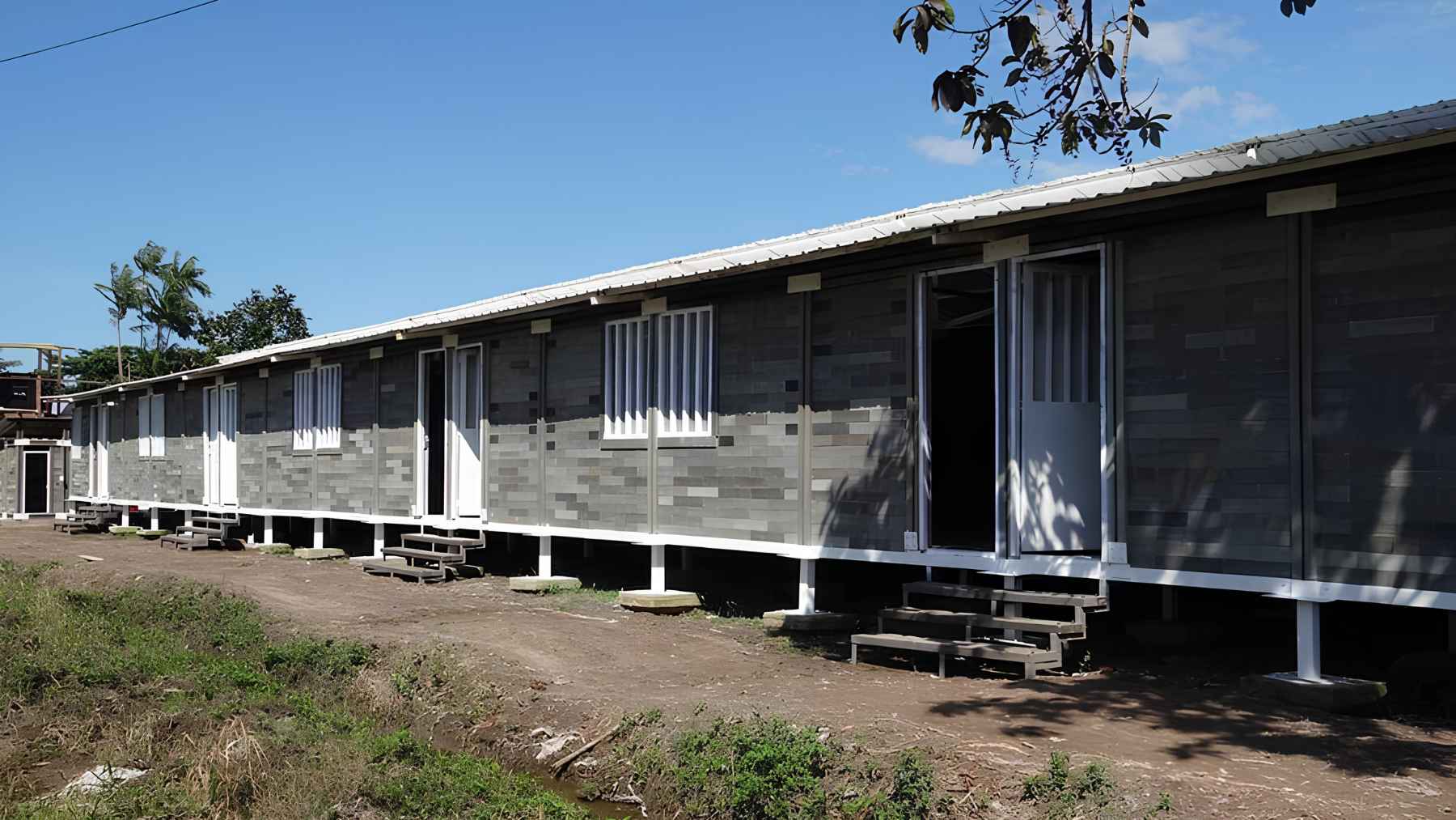 Row of houses built with recycled plastic bricks as part of a fast modular construction system.
