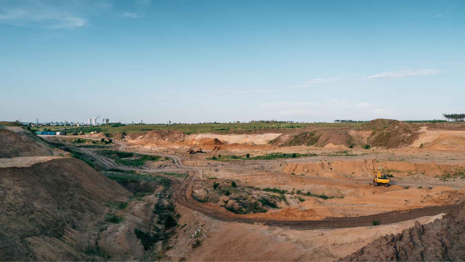 Large sand quarry with excavators extracting sand, illustrating industrial-scale sand mining linked to global shortages.