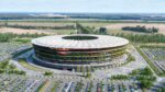 Aerial view of Serbia National Football Stadium in Belgrade, showing circular design with green terraces and surrounding parking areas.