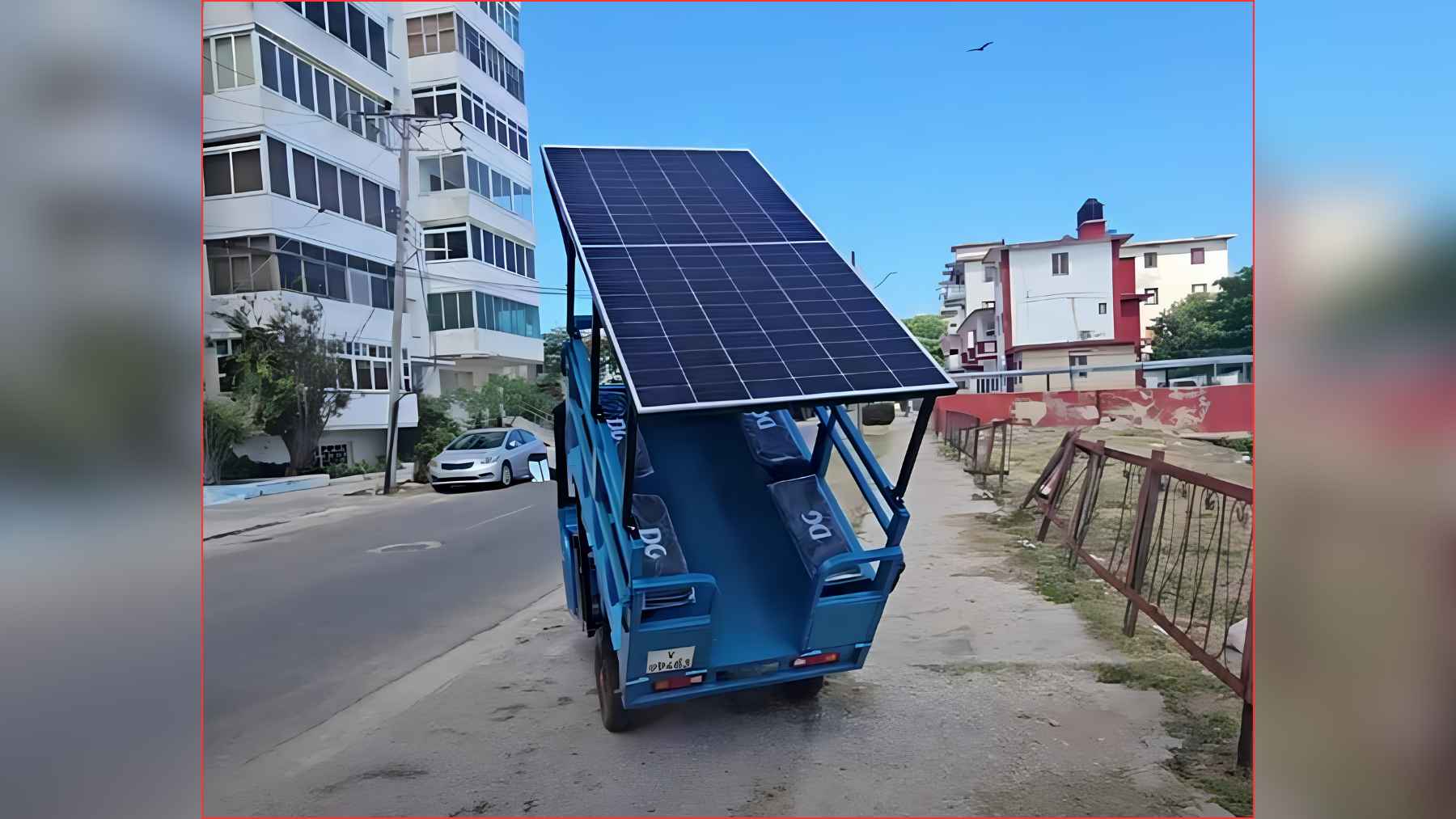 Electric tricycle with a rooftop solar panel installed on a street in Havana, used to extend battery range.