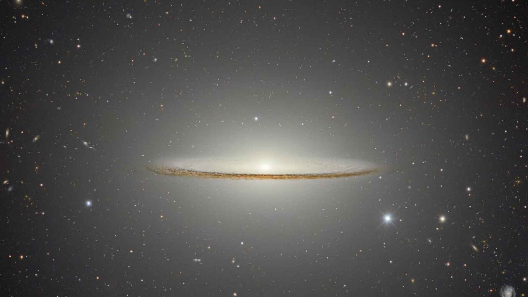 Close-up view of the Sombrero Galaxy showing its bright central bulge, thin dust lane, and faint surrounding halo.