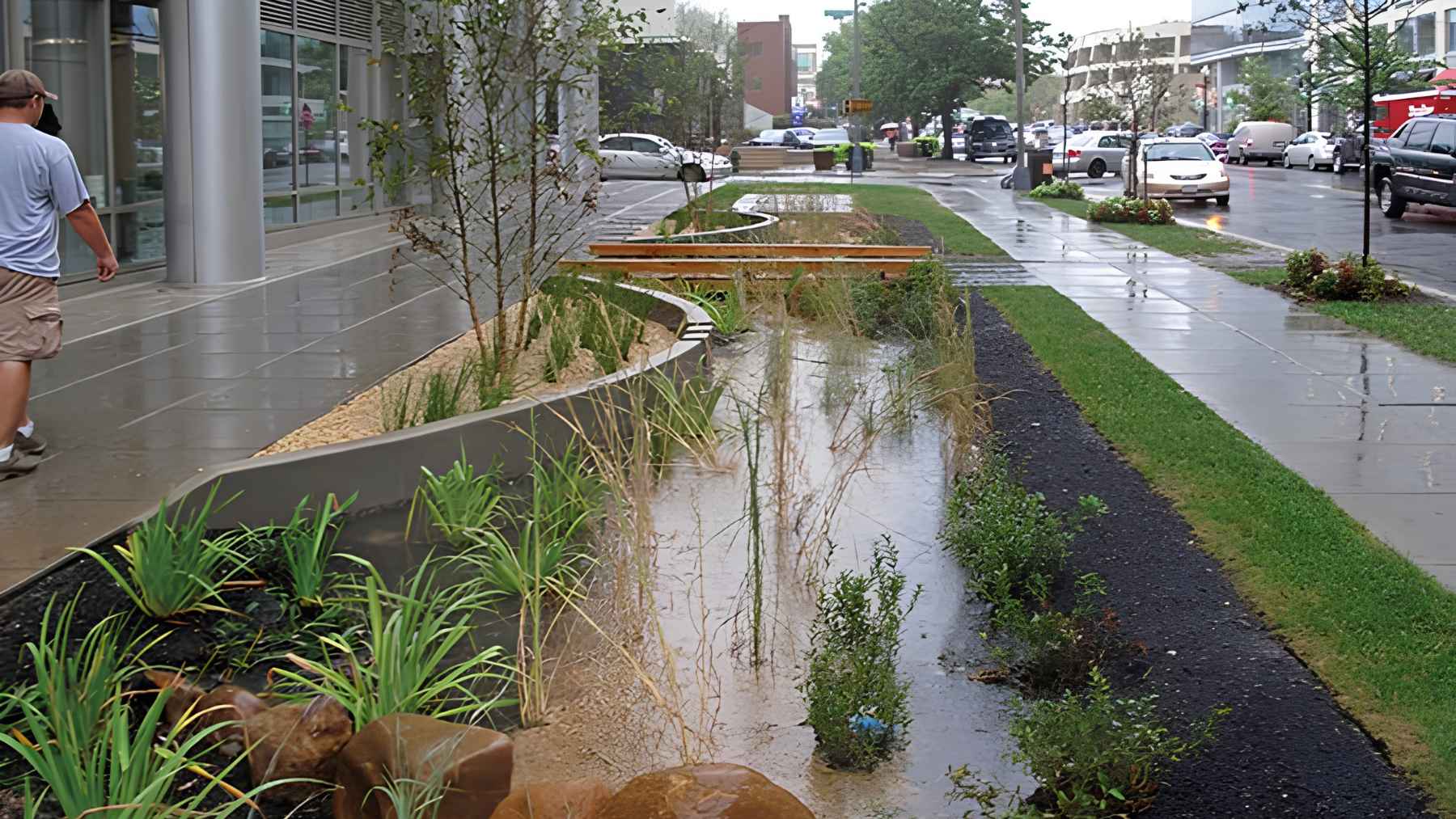 People walk through a flooded neighborhood street after intense rainfall.