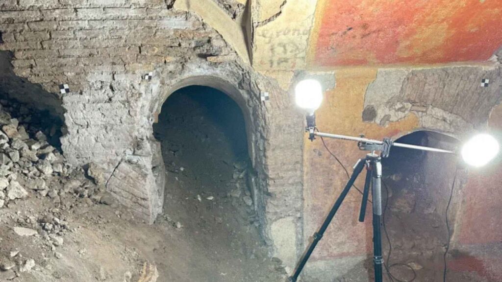 Excavated rooms of the Domus Liceo Cavour beneath a Rome school gym, showing ancient frescoes, vaulted ceilings, and archaeological excavations.