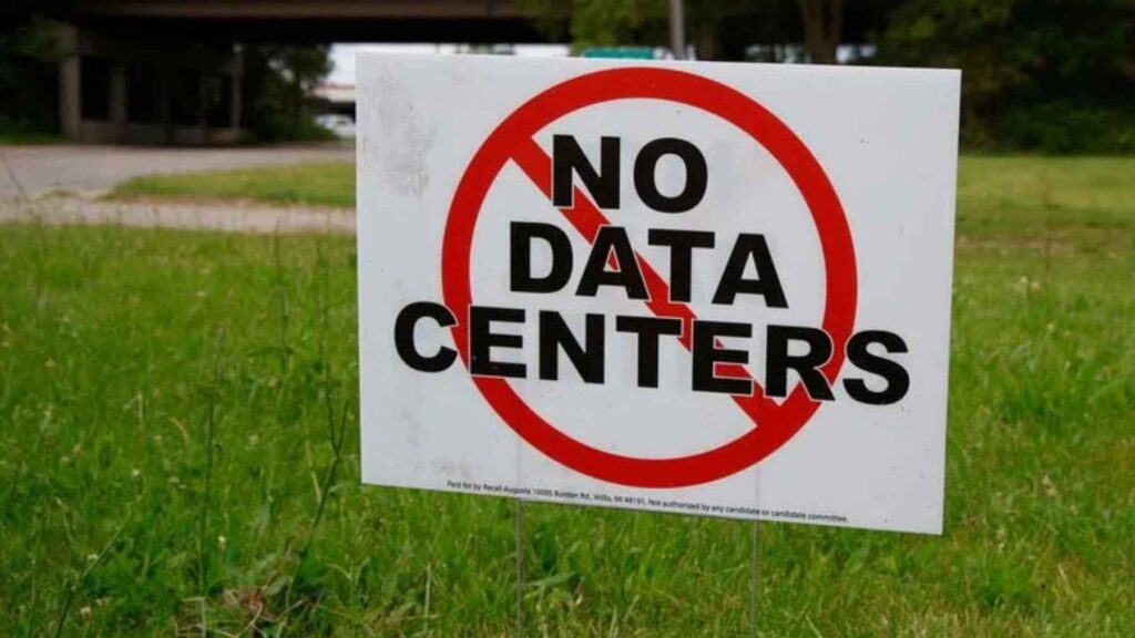 Yard sign opposing the construction of AI data centers, reflecting growing community concerns about transparency and local environmental impacts.