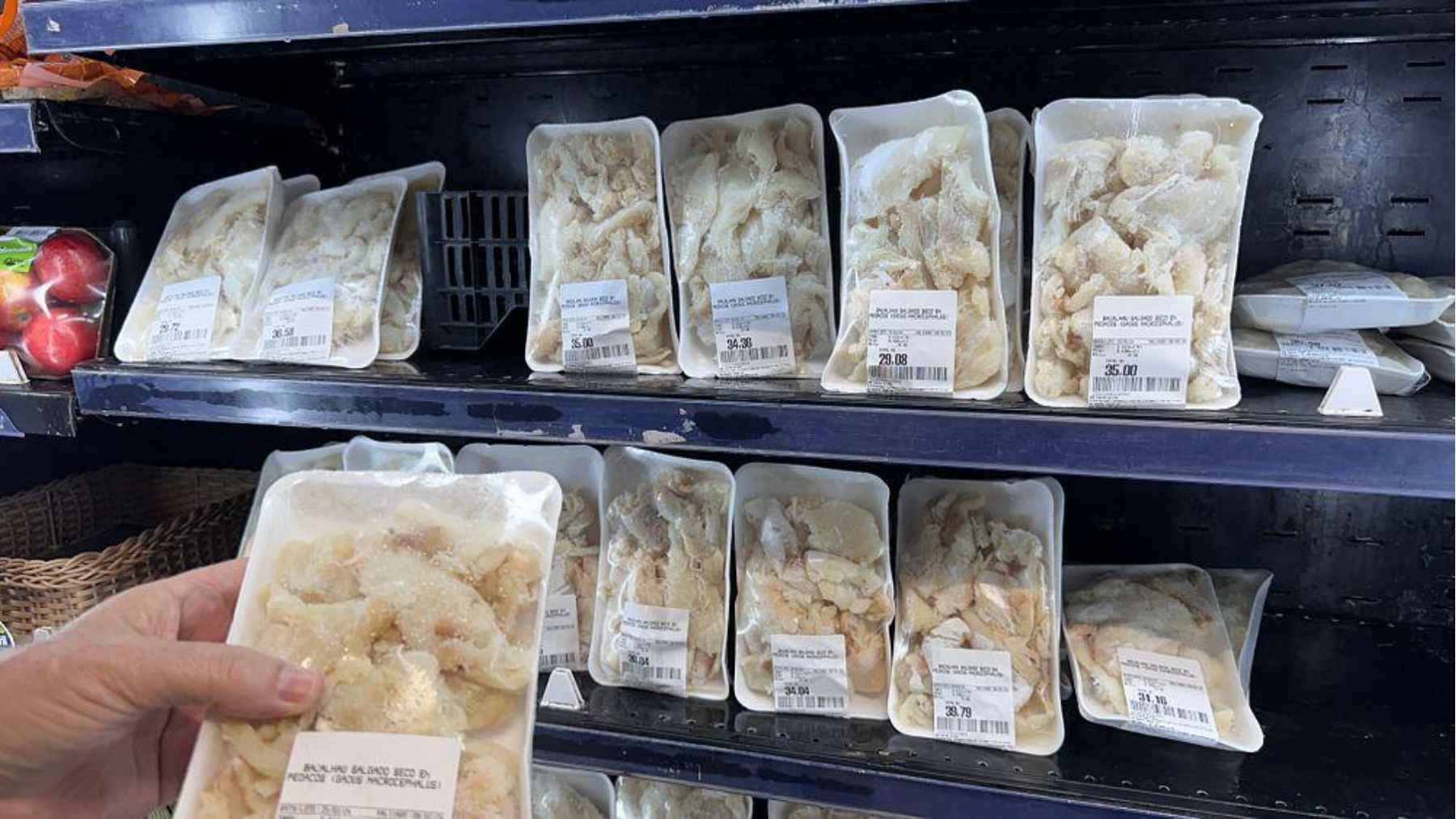 Packaged white fish fillets in supermarket trays, showing affordable frozen pangasius commonly sold in bulk.