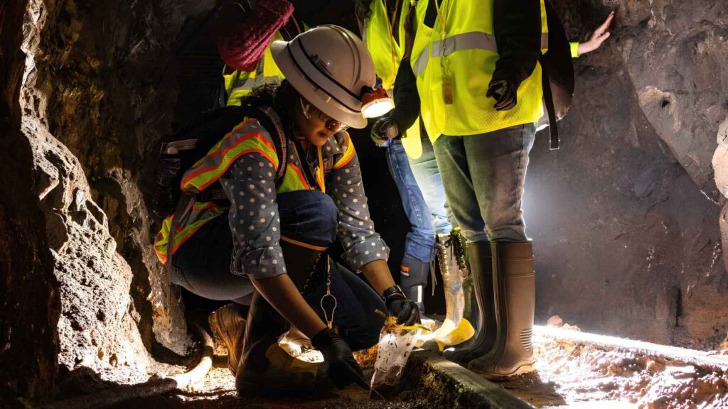 Researchers working inside underground tunnel studying microbes for carbon capture
