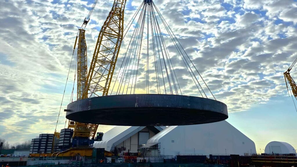 Massive basemat foundation being lowered into place for a small modular reactor.