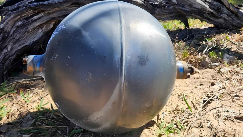 Metallic pressure vessel from a rocket launch vehicle washed ashore at Forrest Beach in Queensland, Australia.