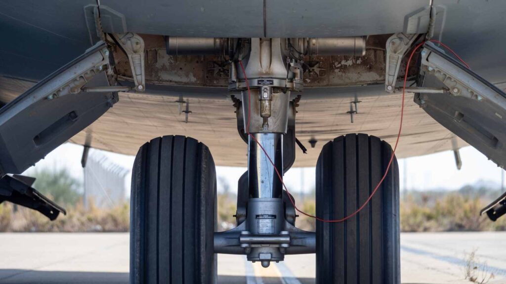 An engineering rendering of a carbon-fiber structural battery component designed for aircraft landing gear integration.