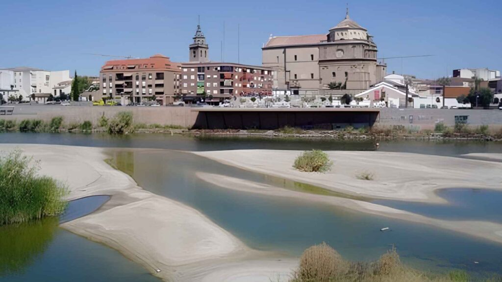 Low water levels in the Tagus River flowing through an urban area in Spain.