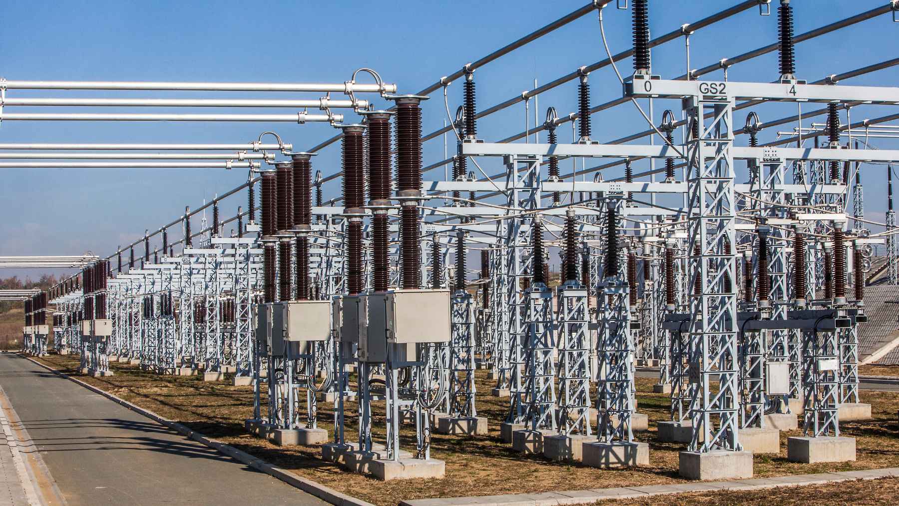 High-voltage electrical substation with transmission equipment, linked to concerns over AI data centers and U.S. grid demand.