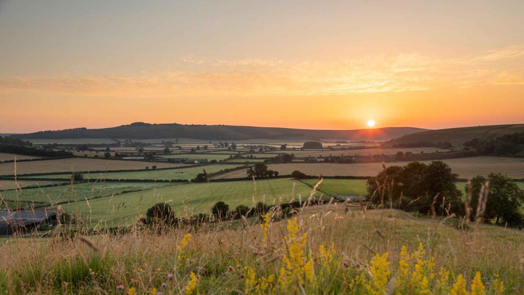 Sunrise over Wiltshire countryside showing horizon used for ancient solstice alignments