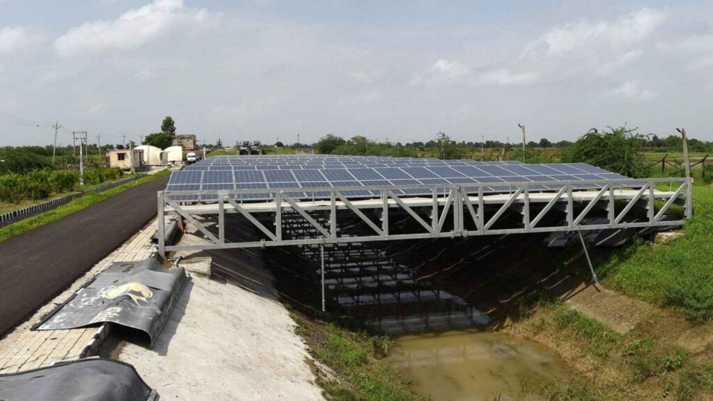 Canal-top solar panels mounted on a steel structure above an irrigation canal in Gujarat, India.