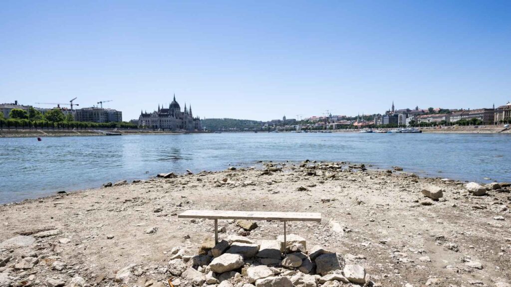Boats navigate unusually low water levels on the Danube River in Budapest during the 2026 drought.