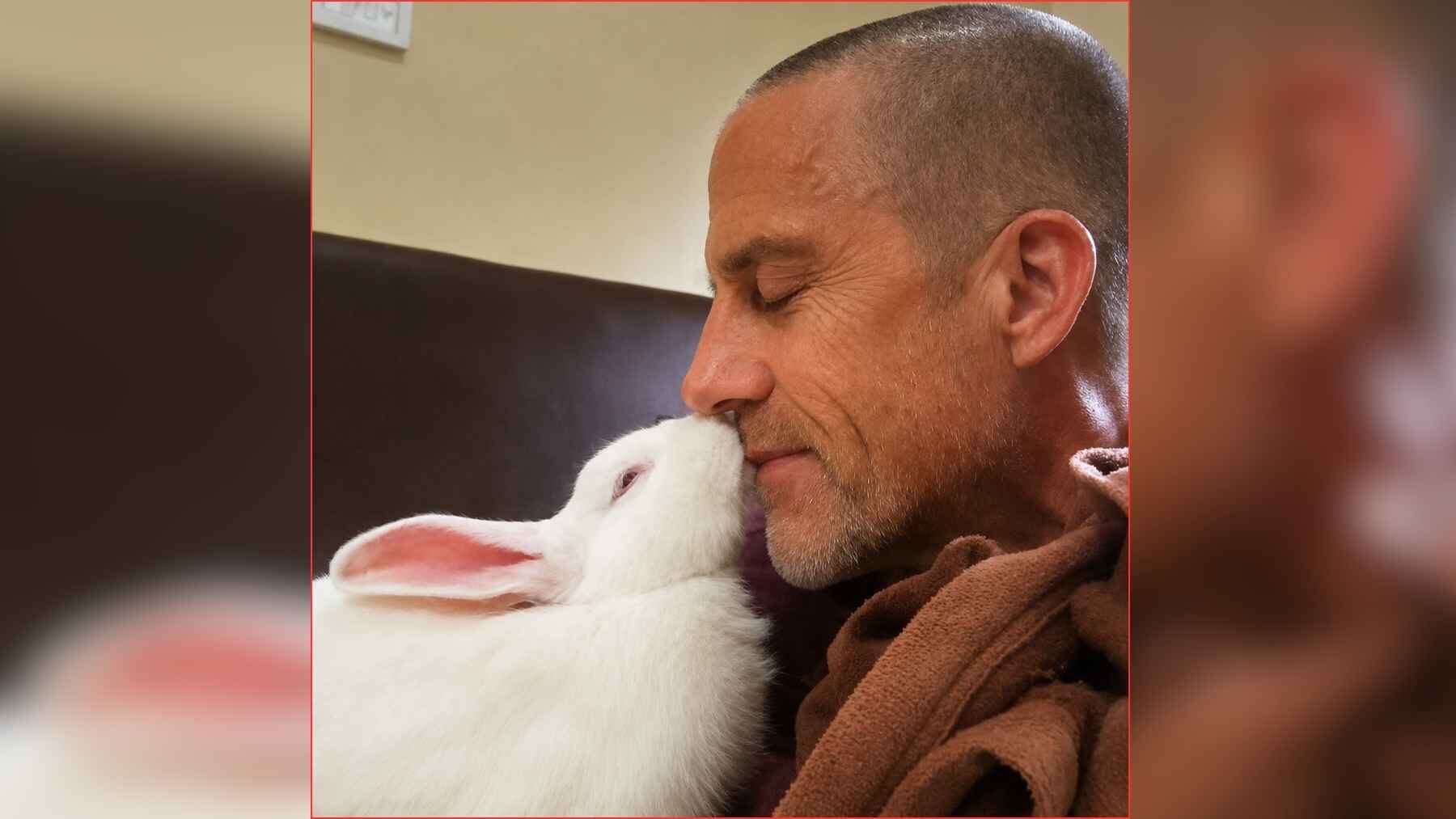 Francis Metivier shares an affectionate moment with Asa after rescuing the white rabbit.
