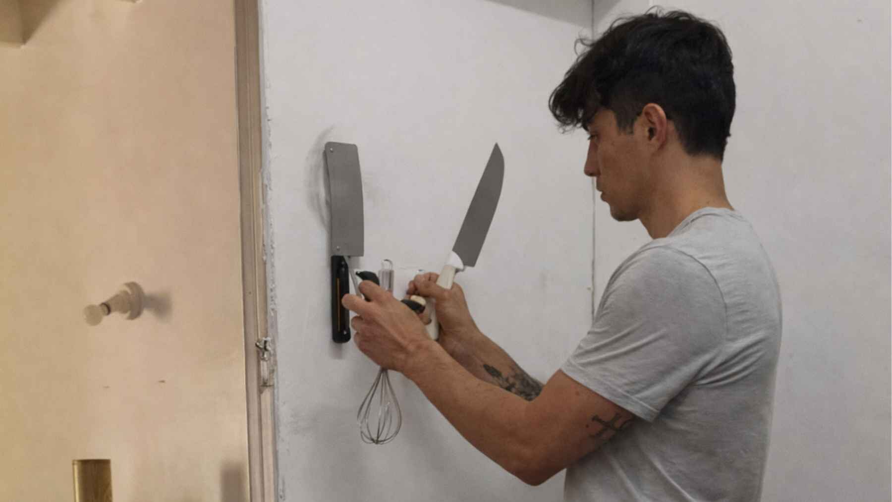 Ironplac magnetic wall demonstration with kitchen tools attached without drilling.