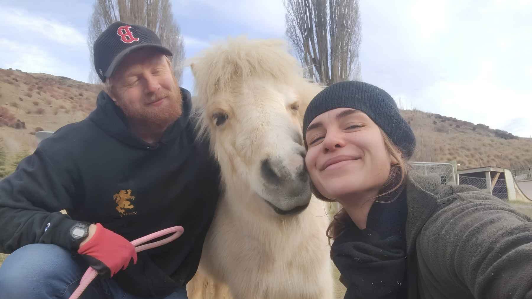 Volunteers posing with a pony at Kind Farm in New Zealand.