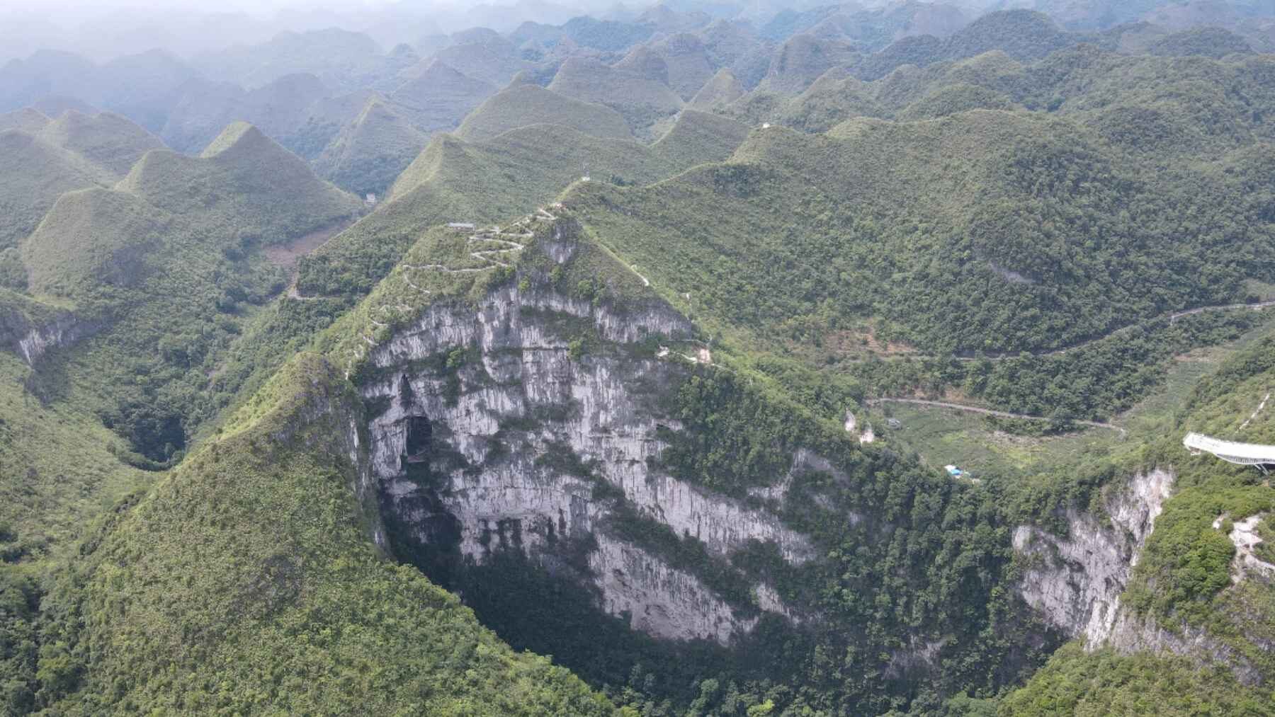 Karst tiankeng surrounded by forest in Leye, Guangxi, China