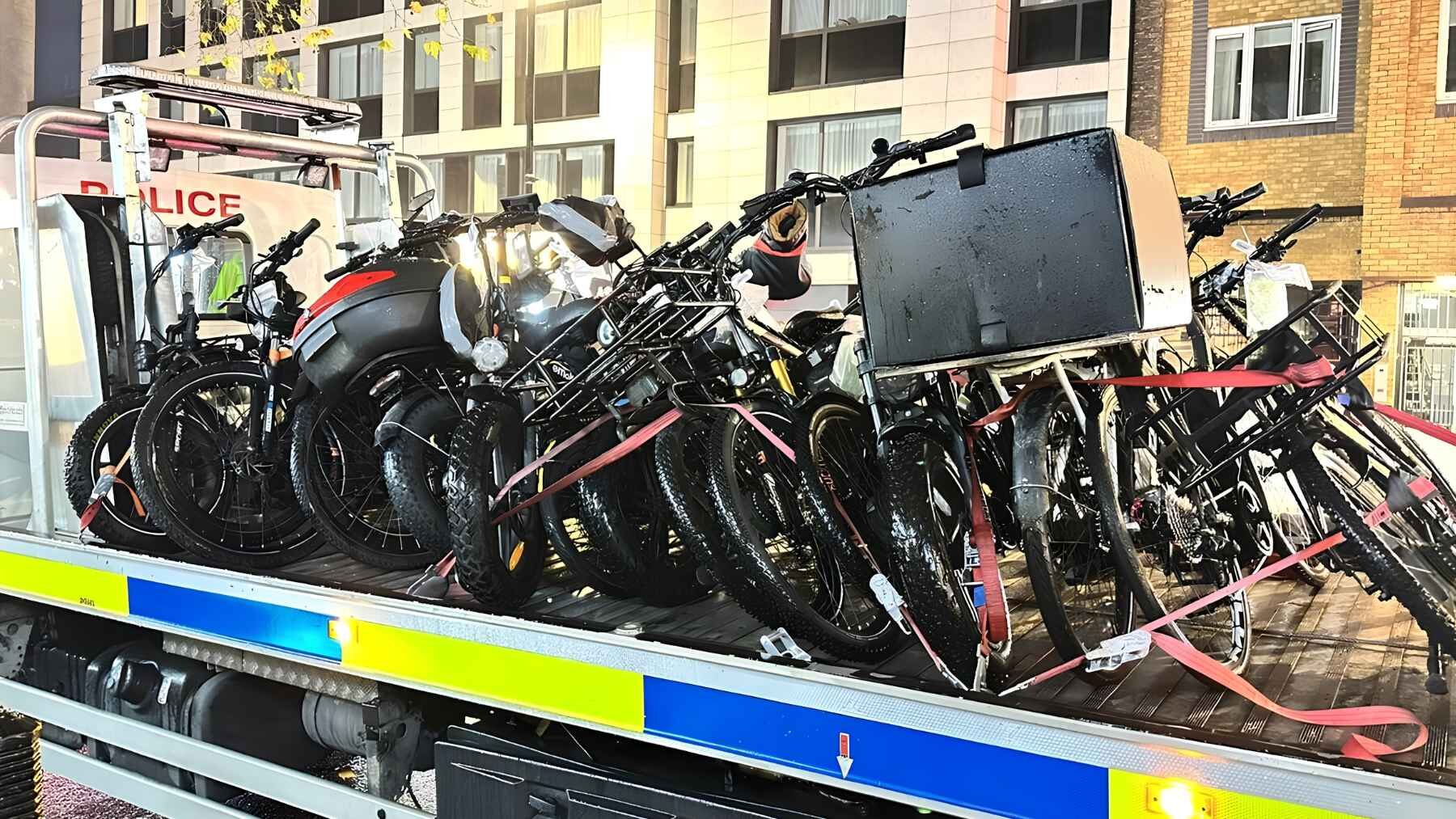 Metropolitan Police truck carrying dozens of illegal e-bikes seized during enforcement operations in London.