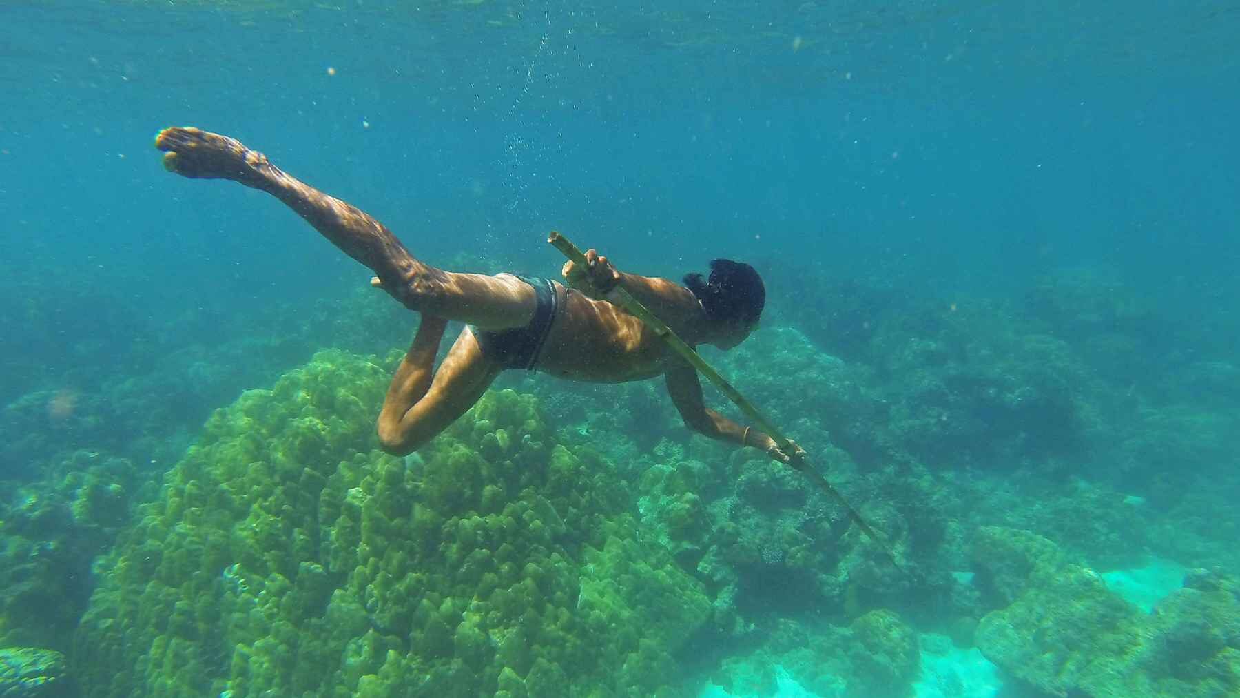 Moken free-diver swimming underwater without goggles in the Andaman Sea.