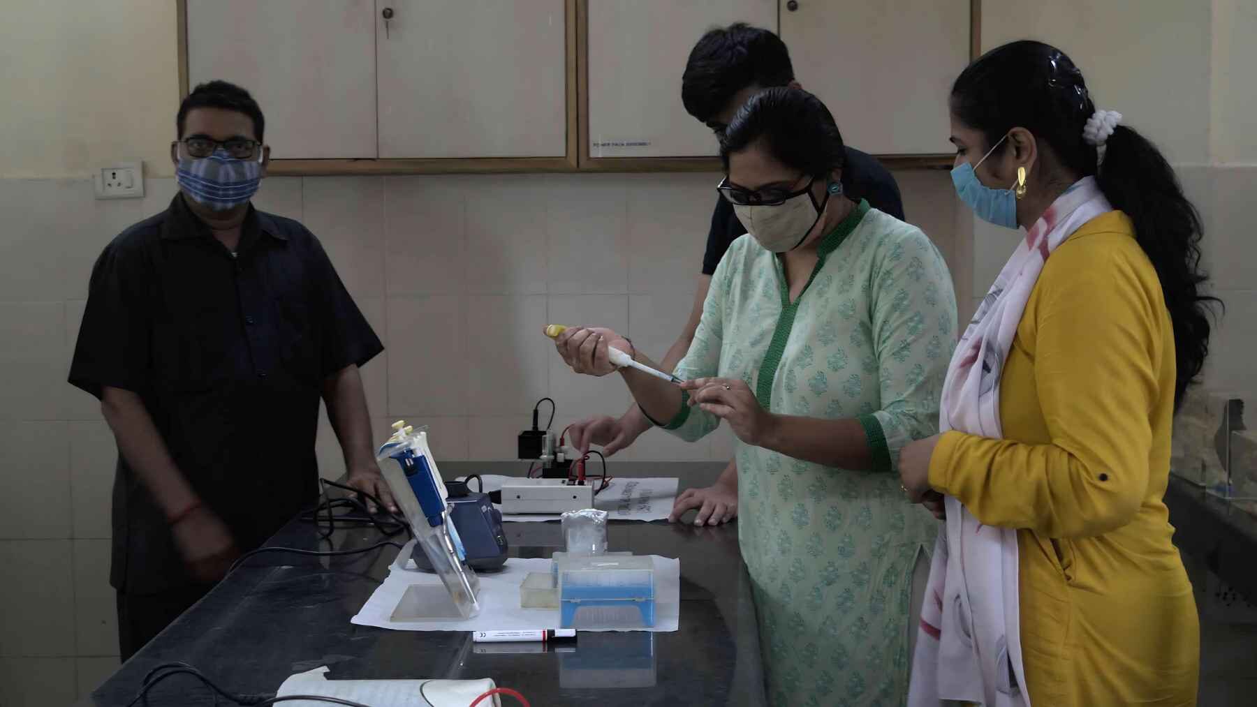 Researchers working inside a laboratory at the University of Delhi in India.