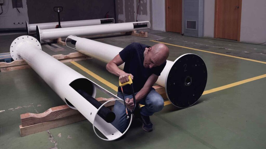 Engineer assembling the Atlantis bladeless wind generator prototype developed by Vortex Bladeless.