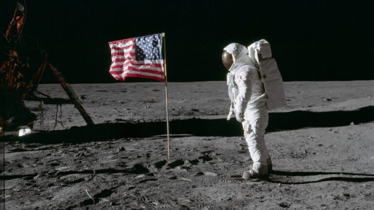 Astronaut Buzz Aldrin stands beside the American flag on the lunar surface during the Apollo 11 mission in July 1969