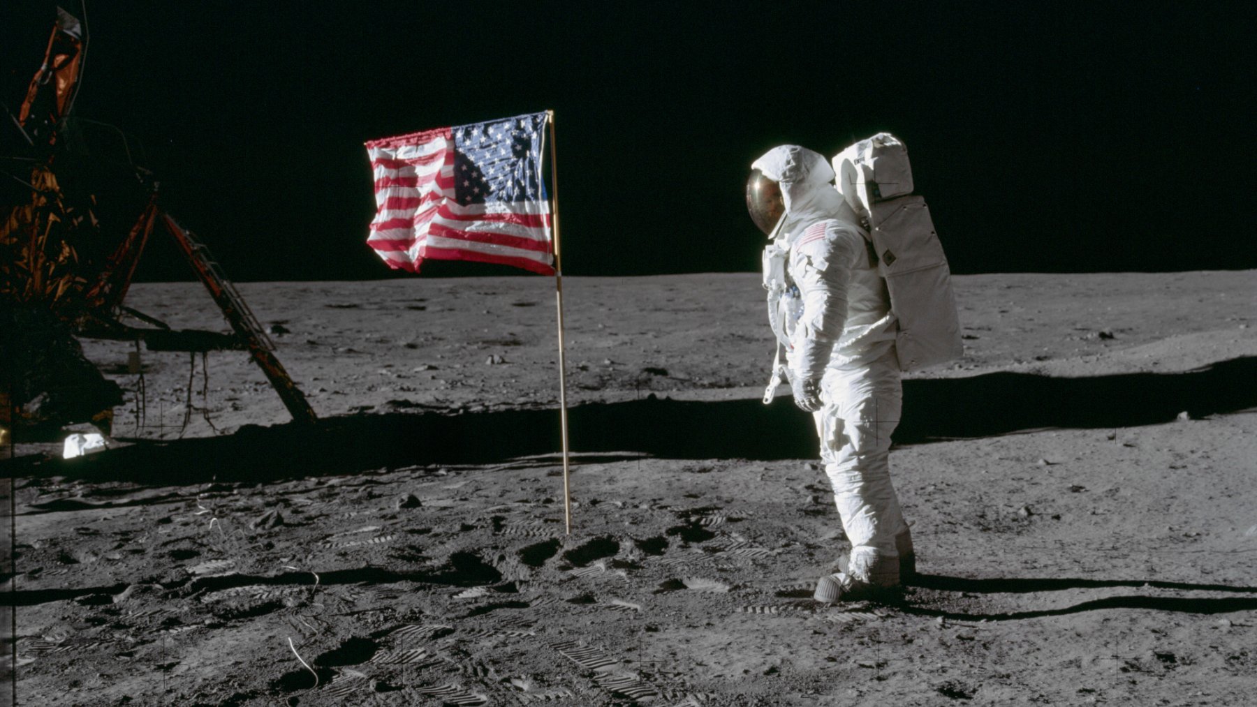 Astronaut Buzz Aldrin stands beside the American flag on the lunar surface during the Apollo 11 mission in July 1969