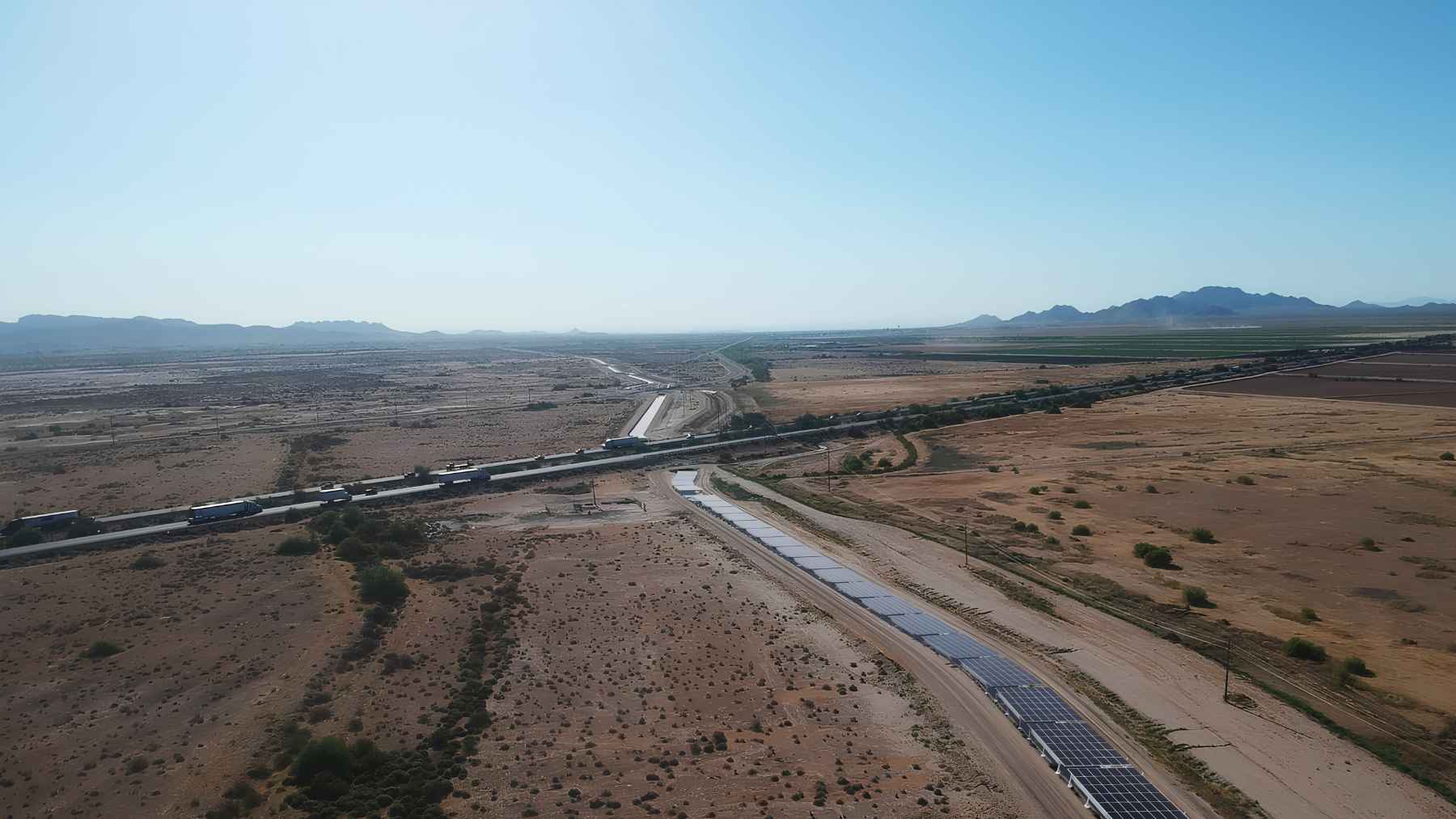 Aerial view of solar panels stretching over the Casa Blanca Canal across the Arizona desert.