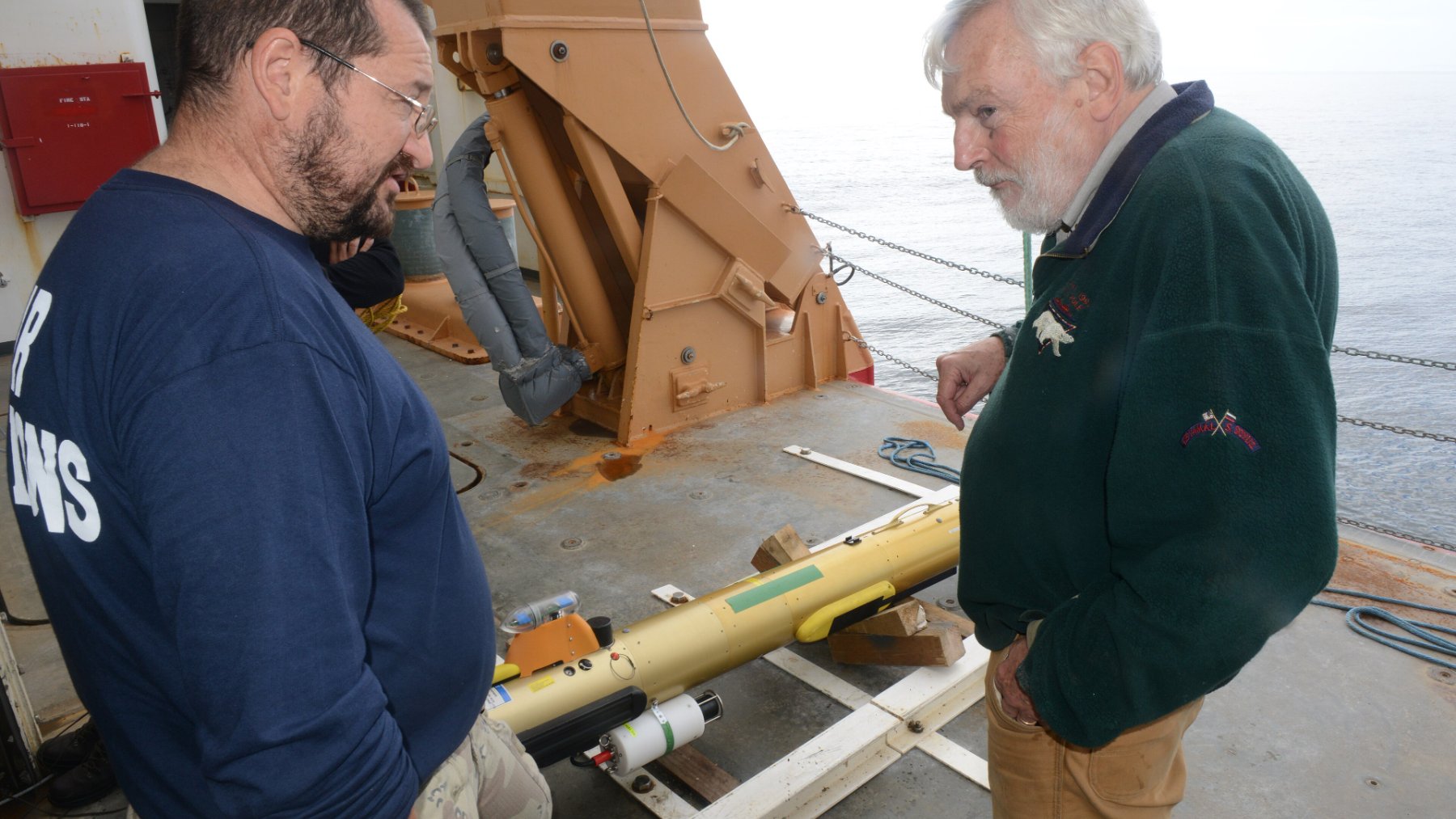 Autonomous underwater vehicle being lowered into the sea from a ship